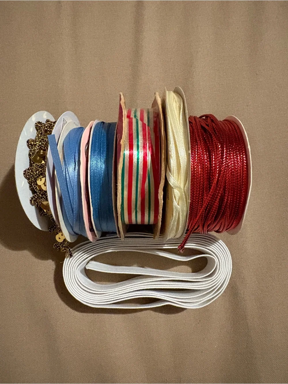 Metallic Tinsel Cord Spool and an Assortment of Ribbons. No Full Spools.